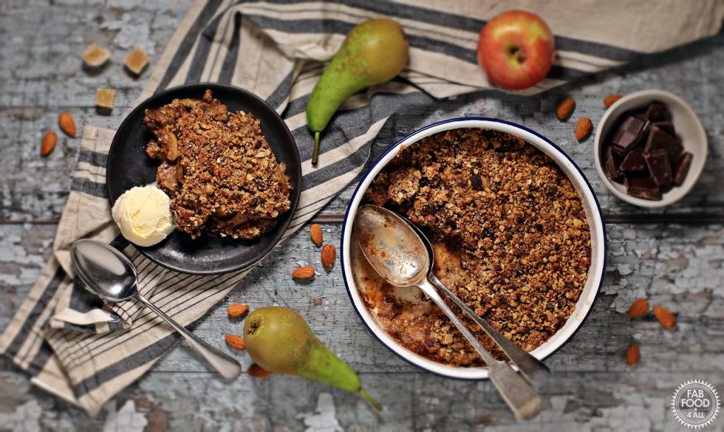 Pear, Chocolate & Ginger Crumble overhead shot with ingredients scattered around. & served with ice cream.