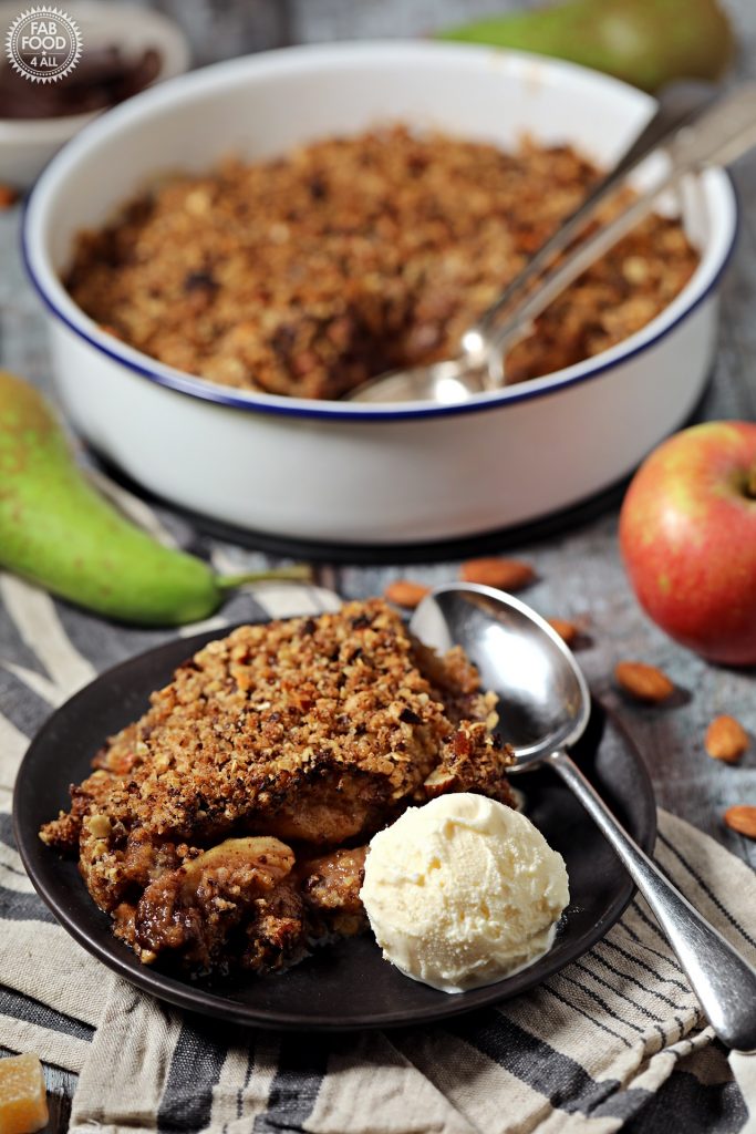 Pear, Chocolate & Ginger Crumble  in dish and served on plate with ice cream.