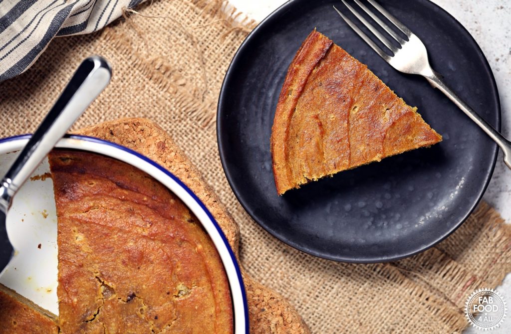Easy Pumpkin Pie Pudding in a pie dish with pie server plus slice on a plate.