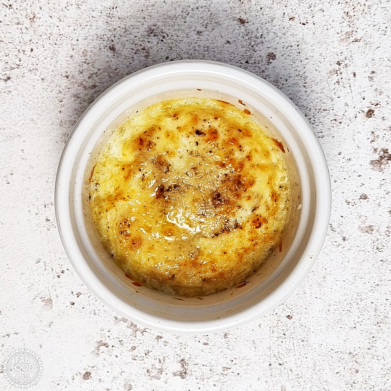 Air Fryer Baked Egg with Cheese in a ramekin.