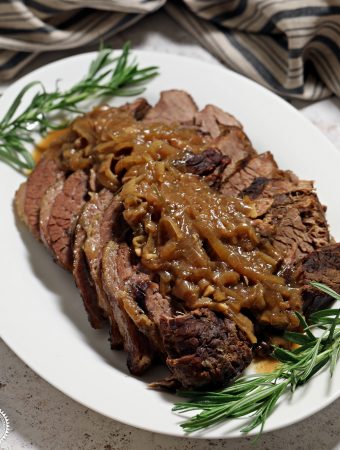 Slow Cooker Beef Brisket with Onion Gravy on a serving platter.
