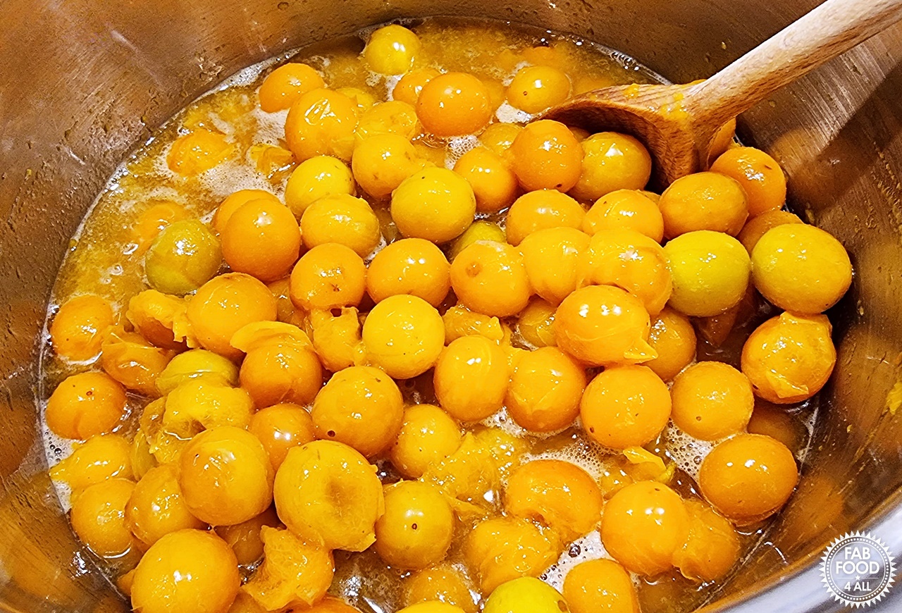 Mirabelle plums simmering with water.