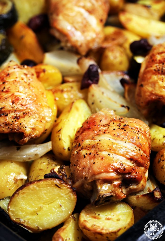 Easy Greek Chicken & Potatoes close up in roasting pan.