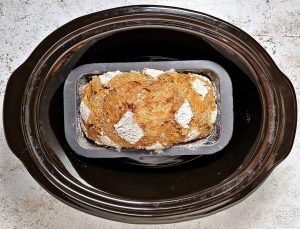 Baked Easy Slow Cooker Sourdough Sandwich Bread in tin in the slow cooker.