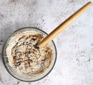 Ingredients being mixed with a Danish whisk to form the sourdough.