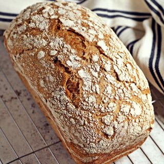 Slow Cooker Sourdough Sandwich Bread on a wire rack.
