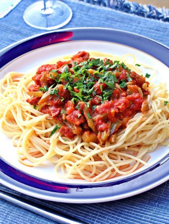 Chorizo & Green Bean Ragu on a bed of spaghetti on a plate.