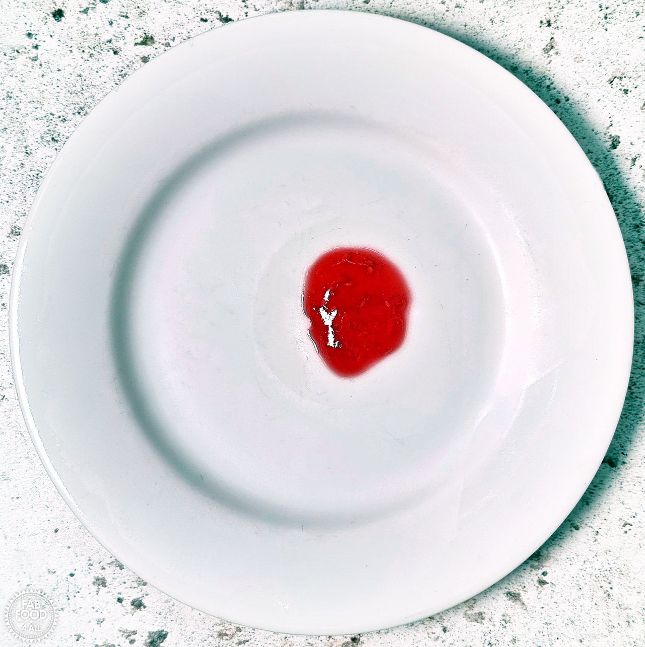 A few drops of hot jam on a chilled plate.