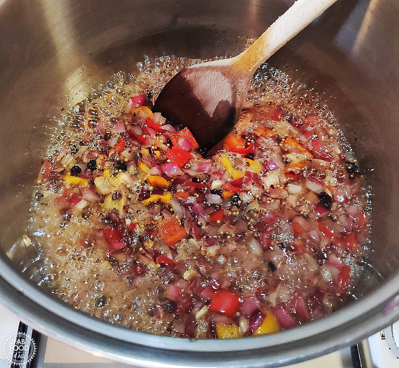 Spicy Baby Tomato & Sweet Pepper Chutney boiling in a pan before cherry tomatoes are added.