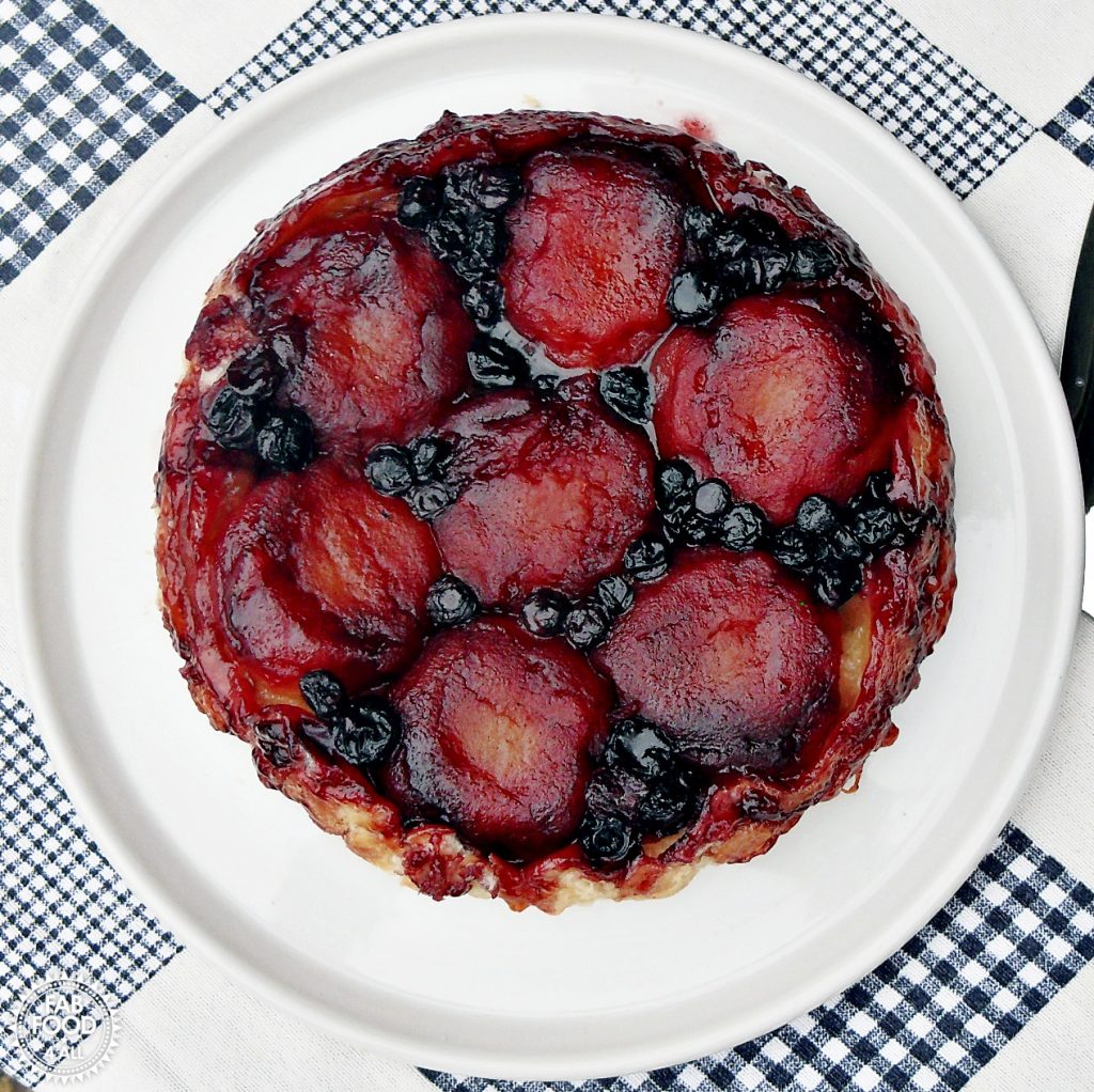 Apple & Blueberry Tarte Tatin on a white serving platter -overhead view.