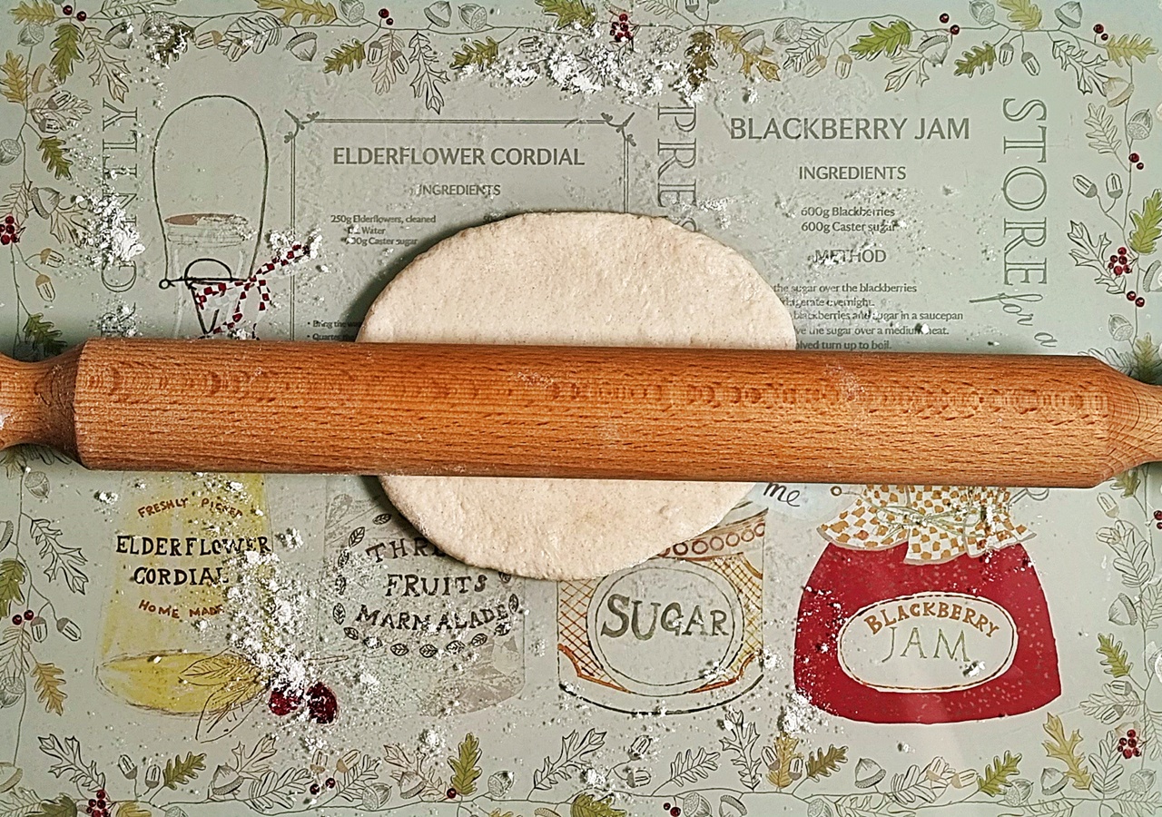 Easy Spelt Yogurt Flatbread dough being rolled out with a rolling pin.