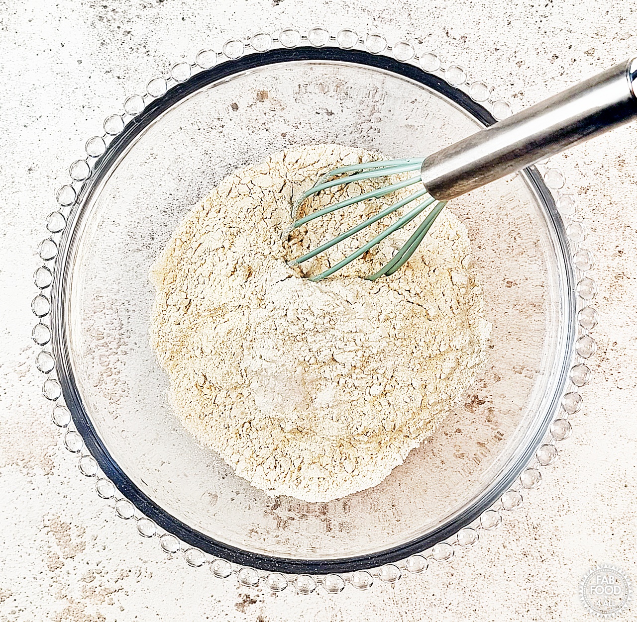 Spelt flour, baking powder and salt being mixed with a whisk.