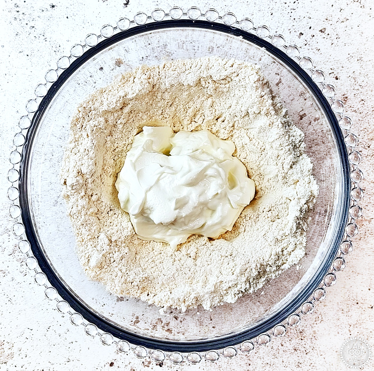 Bowl with spelt flour, baking powder, salt and Greek yogurt in a well in the centre.