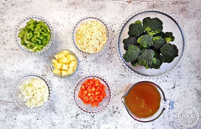 Prepped ingredients: chopped celery, potato, broccoli florets, onion, carrot and made up stock.