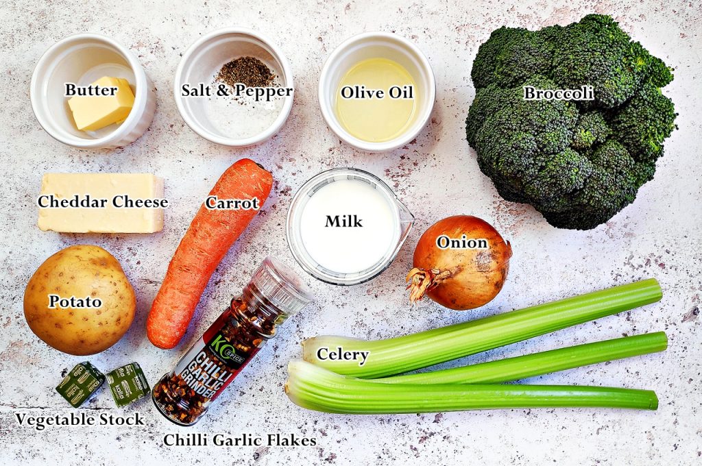 Easy Broccoli Cheddar Soup recipe ingredients: butter, salt and pepper, olive oil, broccoli, Cheddar cheese, carrot, milk, onion, 2 stock cubes, chilli/garlic grinder and 3 sticks of celery.