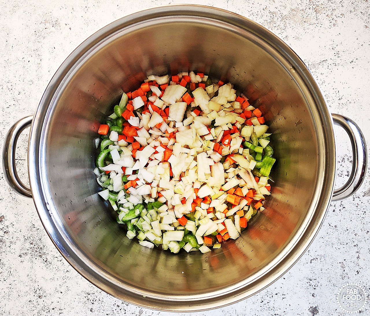 Carrot, onion and celery (mirepoix) in a pan cooking on a low heat in butter and olive oil.