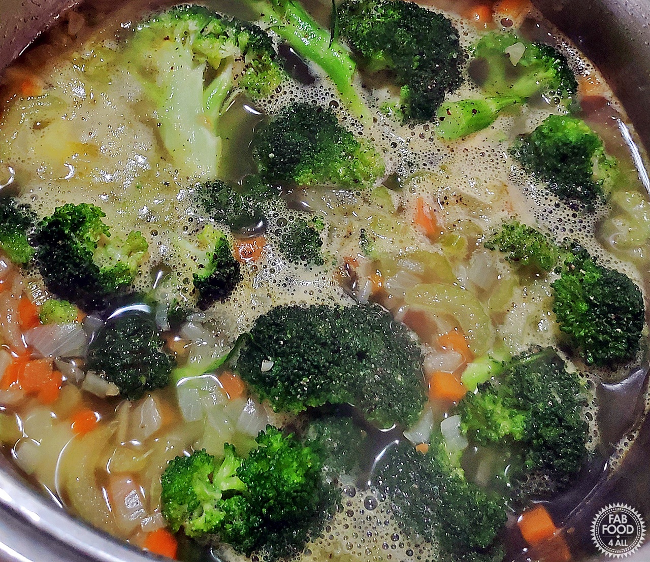 Broccoli Cheddar Soup ingredients being brough to a boil and then lowered to a simmer.