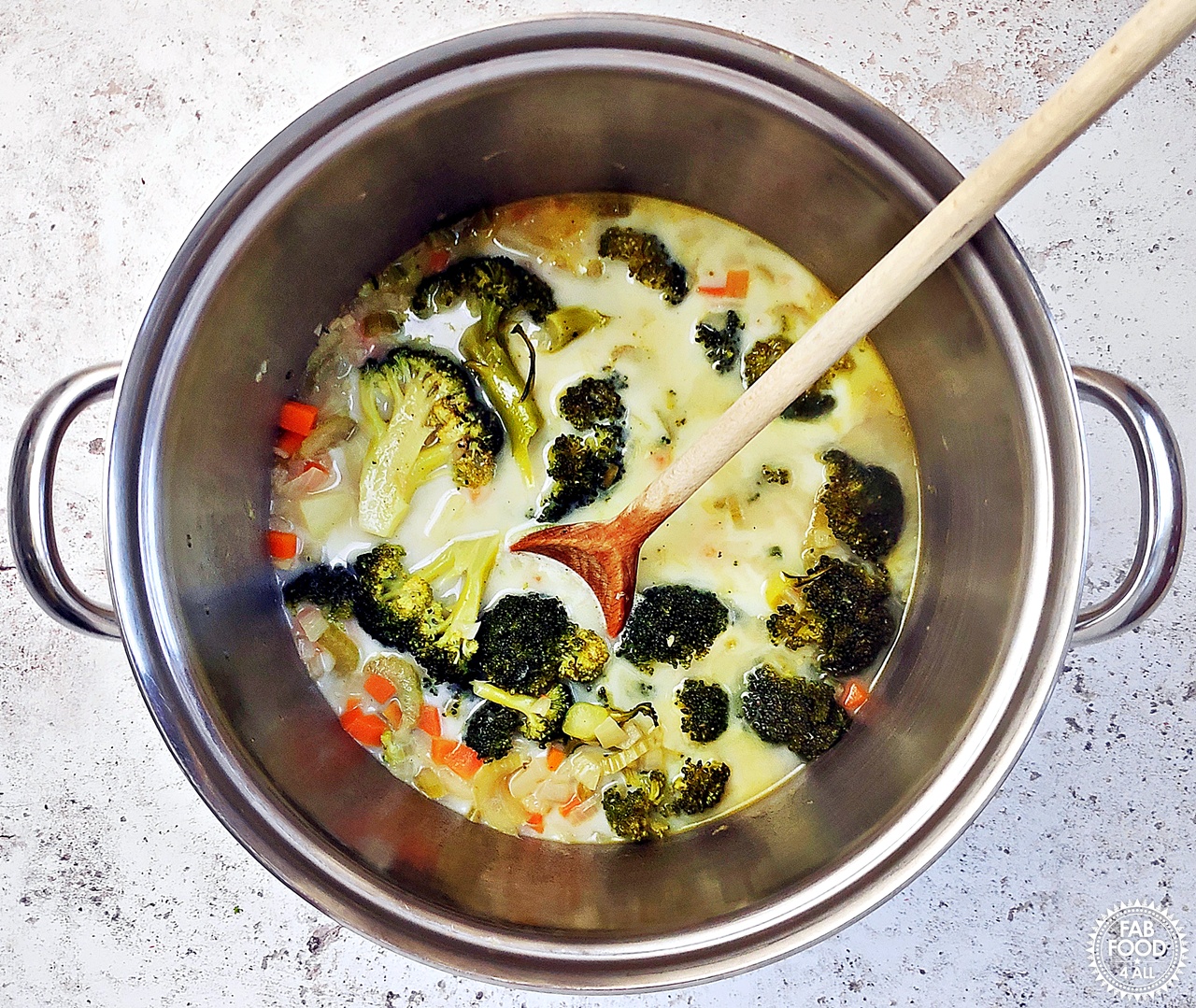Milk added to pan of Broccoli Cheddar Soup after simmering.