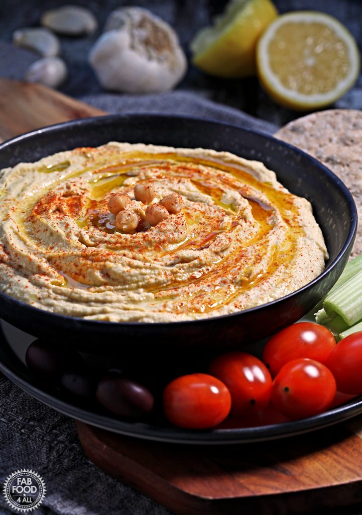 Close up of dish of houmous surrounded by crudites.