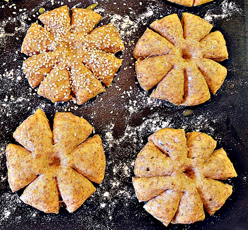 Raw Pumpkin Patch Rolls dough on a baking sheet.