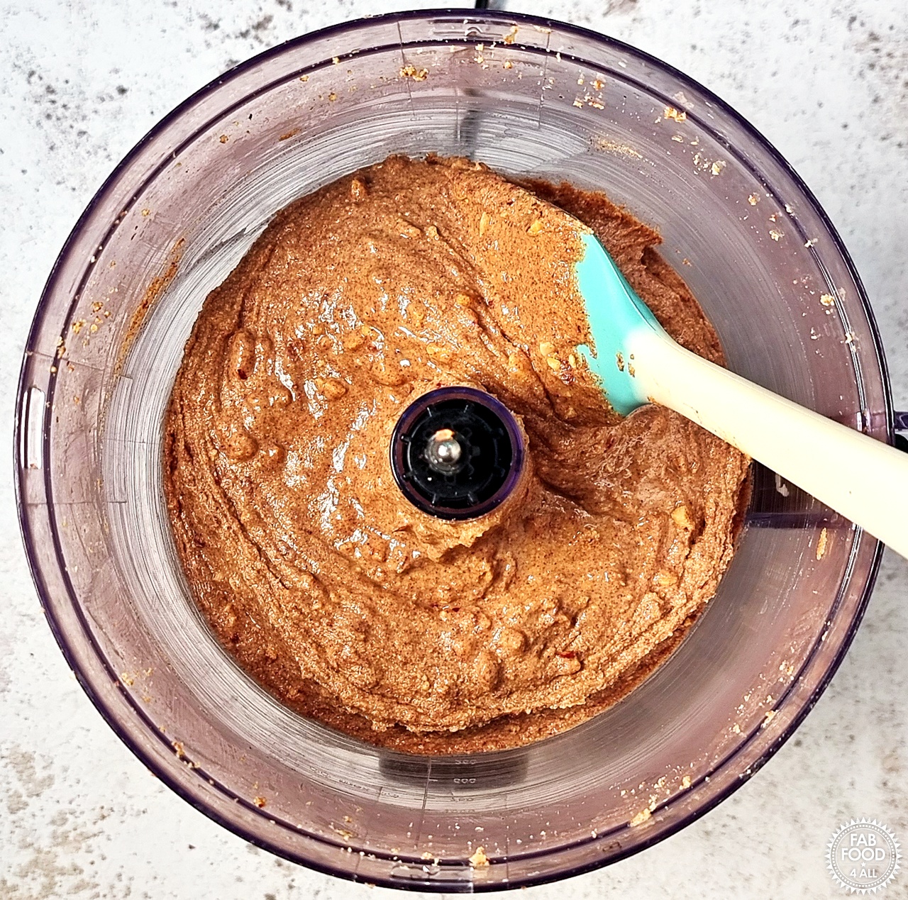 Chopped nuts fully mixed in to the smooth peanut butter with a rubber spatula.