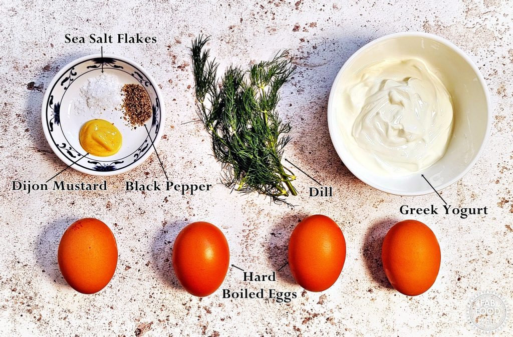 Healthy Egg Salad with Greek Yogurt Ingredients (from left to right): Sea Salt Flakes, Dijon Mustard, Black Pepper, Dill, Greek Yogurt and Hard Boiled Eggs.
