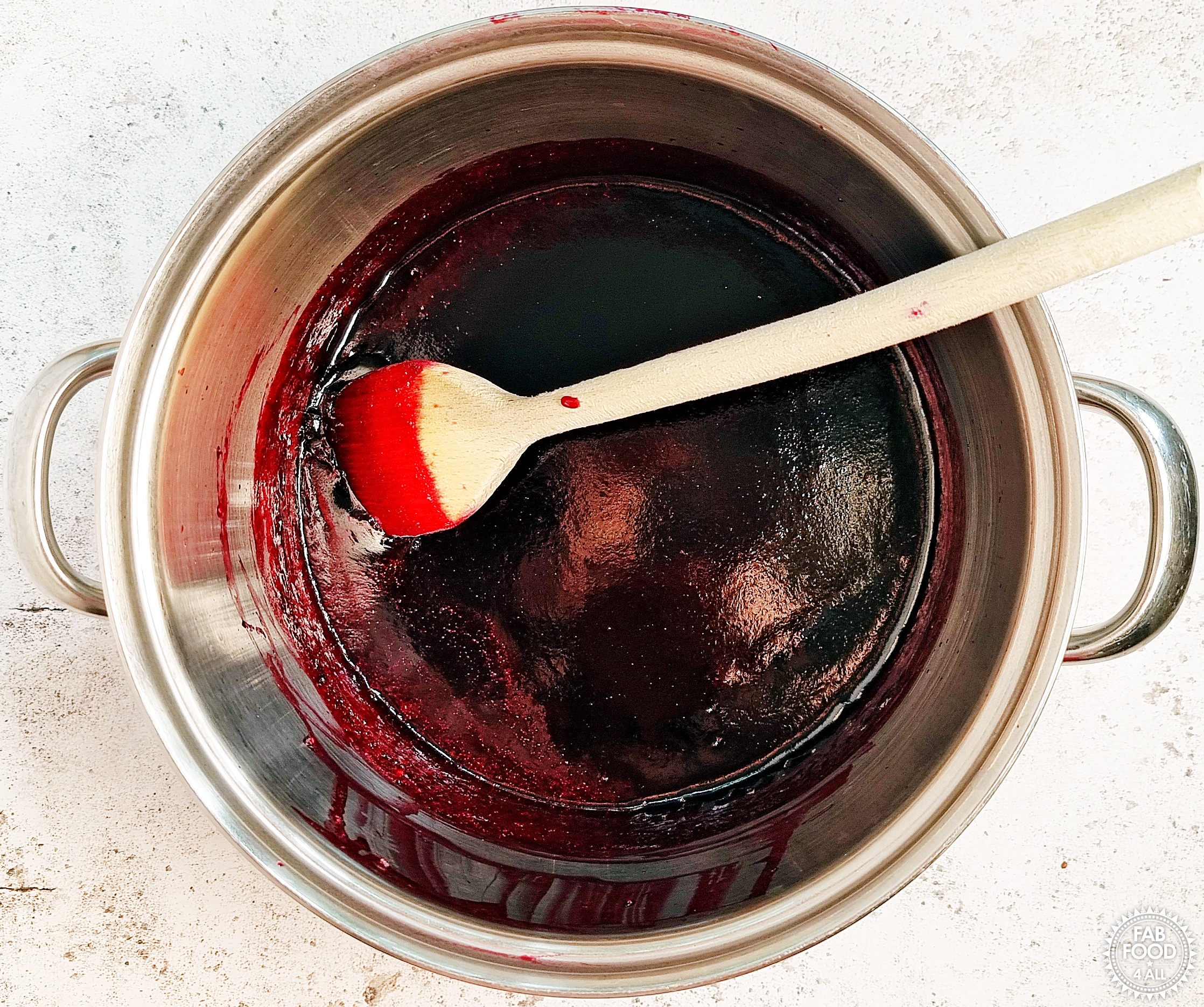 Stirring the Seedless Blackberry & Apple Jam before potting up to remove scum (air bubbles).