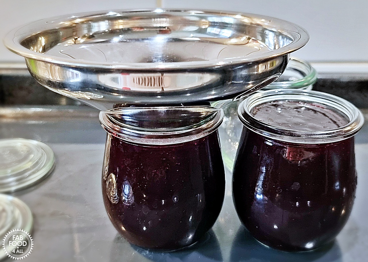 Potting up Seedless Blackberry & Raspberry Jam using a jam funnel - showing 2 full jar and 1 empty.