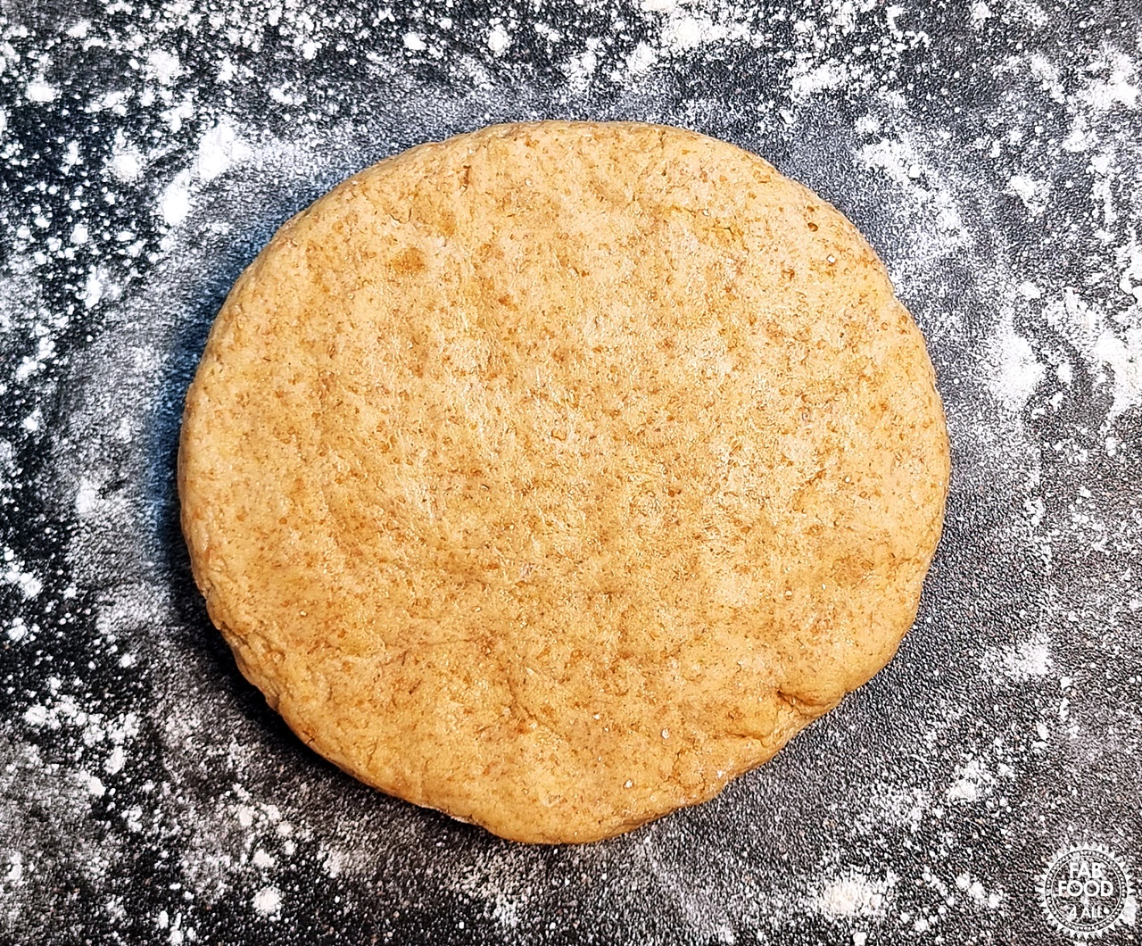 Spelt scone dough flattened to a depth of 2.5 cm on a floured surface.