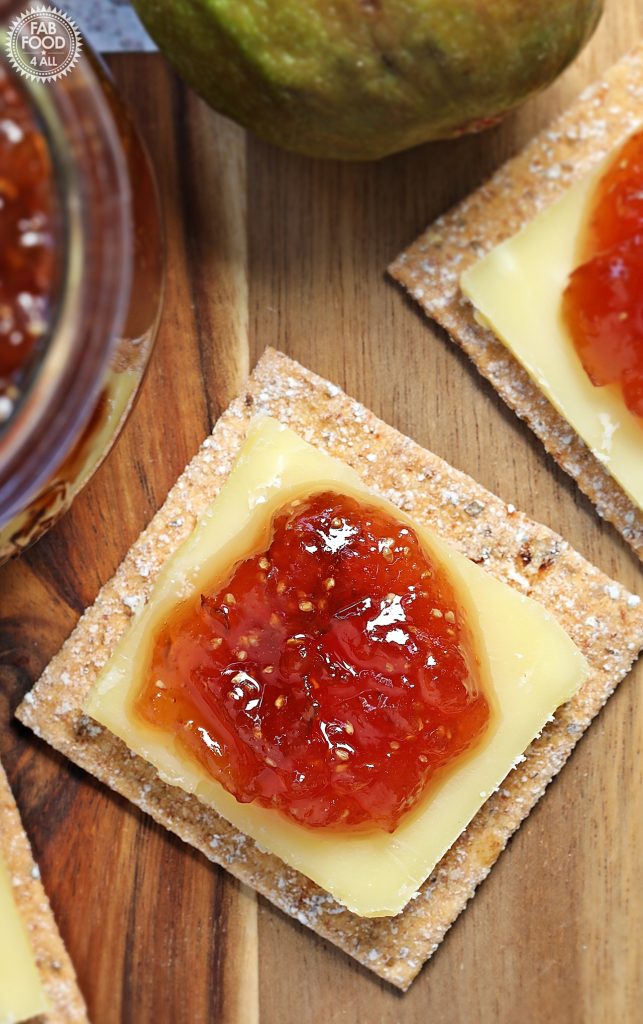 Simple Fig Jam on a cracker with a slice of cheddar cheese.
